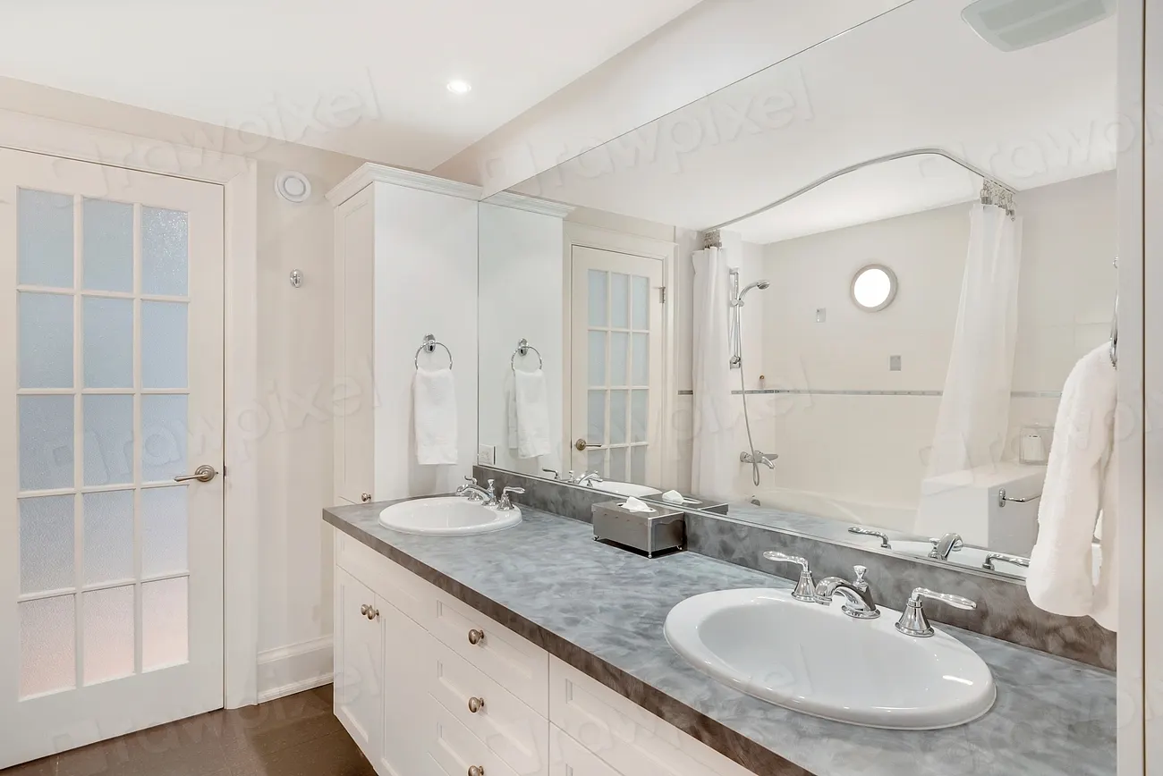 A white double vanity with a grey stone top